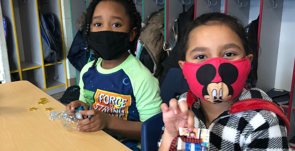 Syracuse Academy of Science and Citizenship 2nd-grade students participated in a holiday arts and crafts activity where they decorated ornaments.